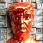 A golden trump head stands before stacks of money.