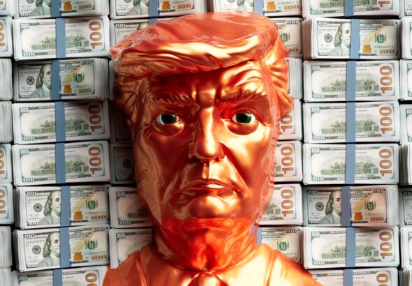 A golden trump head stands before stacks of money.
